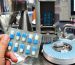 hand-holding-blue-capsule-pack-medicine-pill-production-line-industrial-pharmaceutical-concept_67340-446